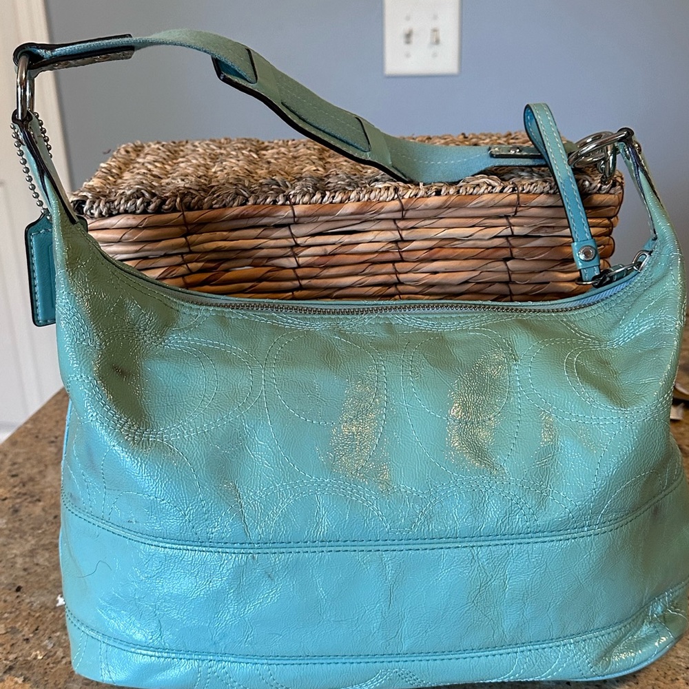 Teal pattern leather Coach shoulder bag.